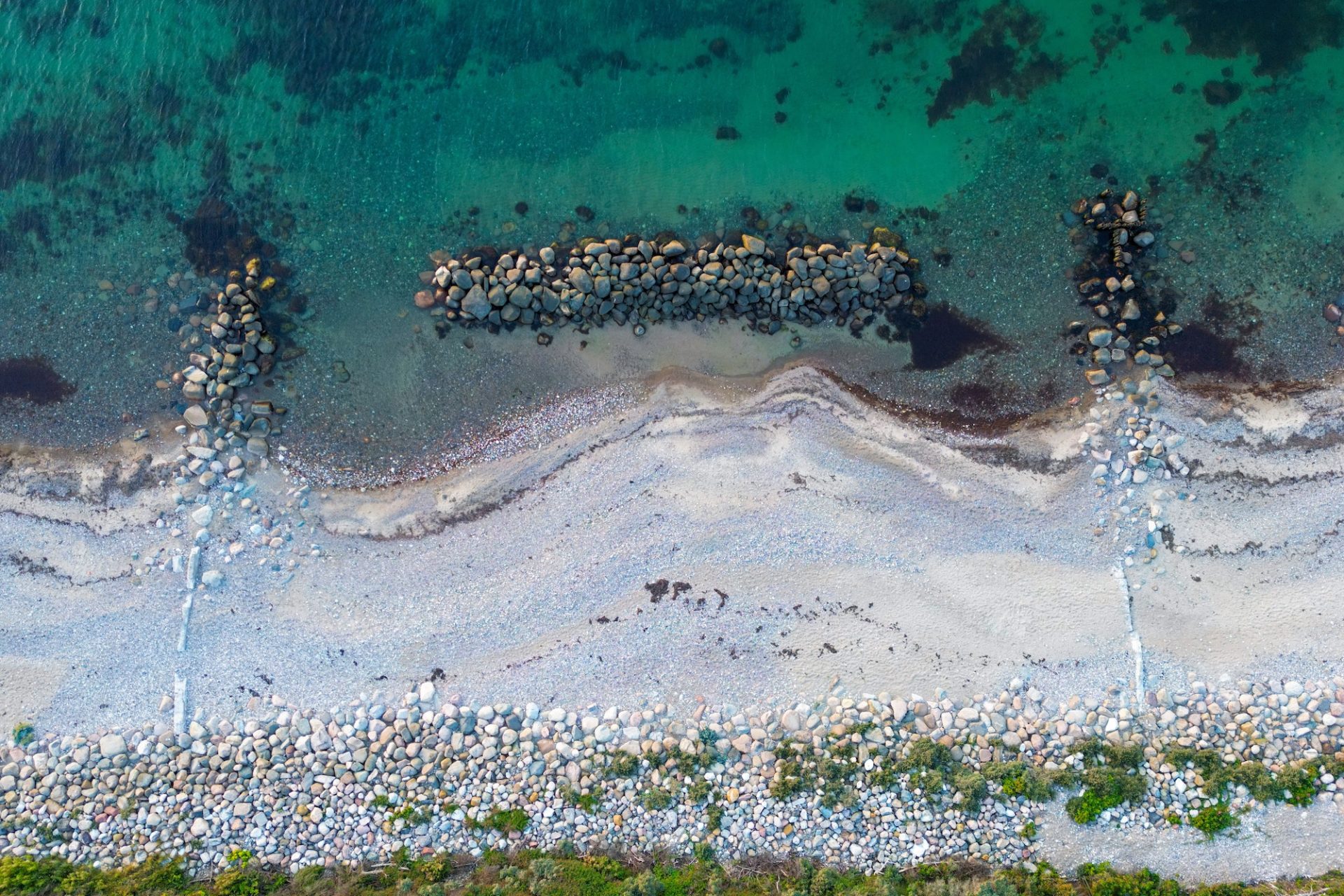 Aerial shot of Gilleleje beach with white sand and blue ocean water in Denmark